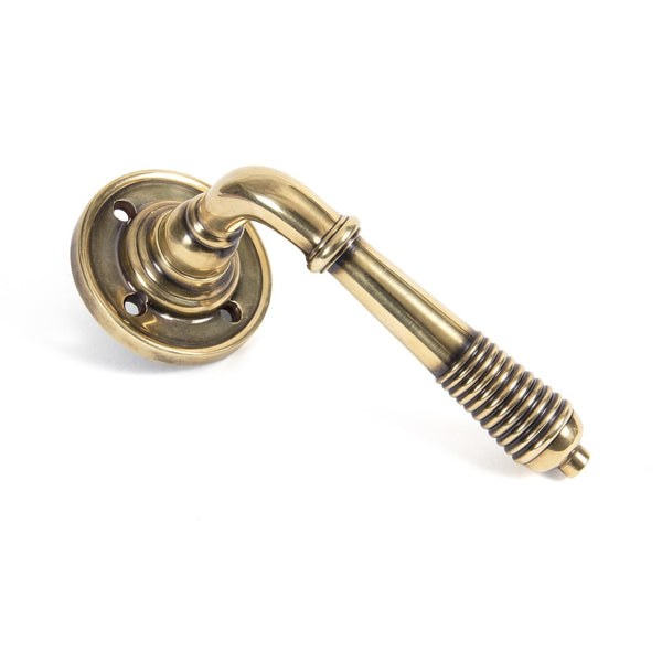 From The Anvil Reeded Lever Handles on Round Rose - Aged Brass