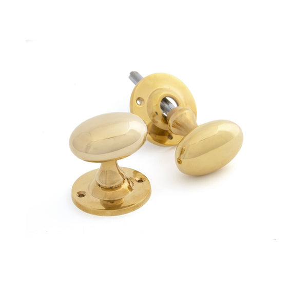 From The Anvil Oval Knob Handles on Round Rose - Polished Brass