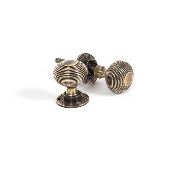 From The Anvil Beehive Knob Handles on Round Rose - Aged Brass