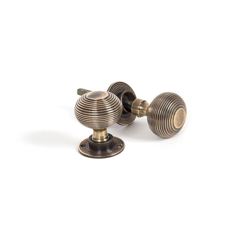 From The Anvil Beehive Heavy Knob Handles on Round Rose - Aged Brass