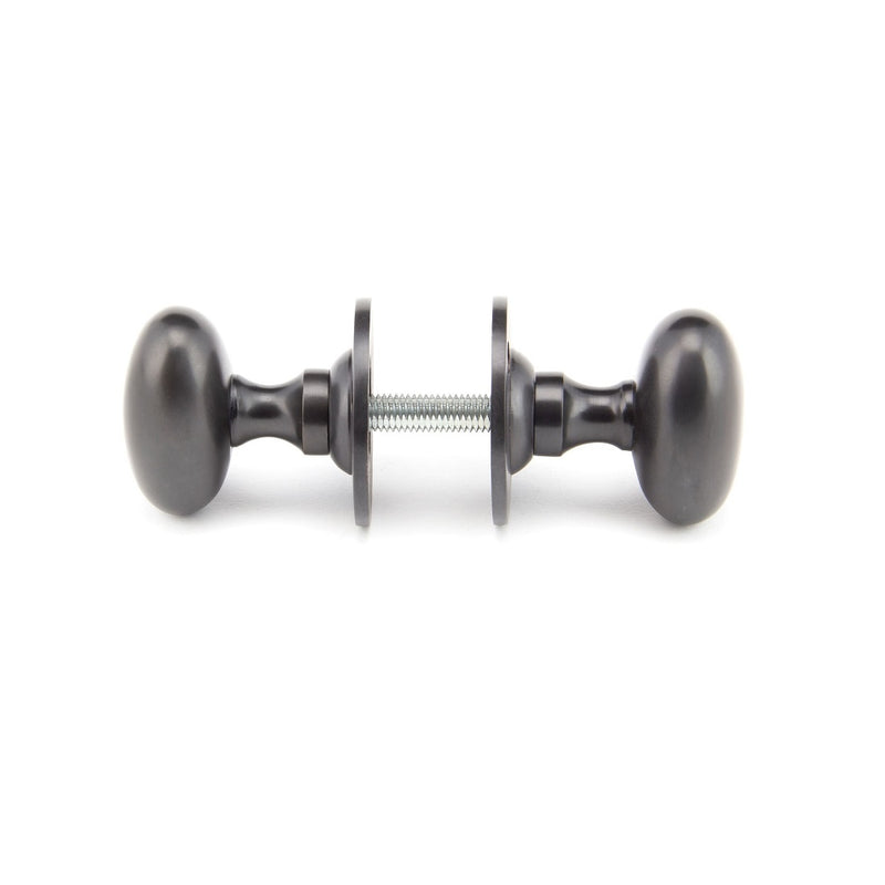 From The Anvil Oval Knob Handles on Round Rose - Aged Bronze