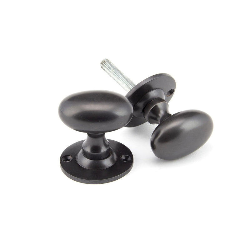 From The Anvil Oval Knob Handles on Round Rose - Aged Bronze