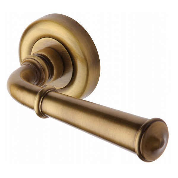 M.Marcus Colonial Lever Handles on Round Rose - Antique Brass