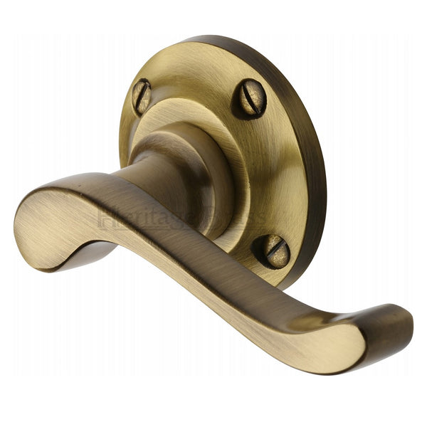 M.Marcus Bedford Lever Handles on Round Rose - Antique Brass
